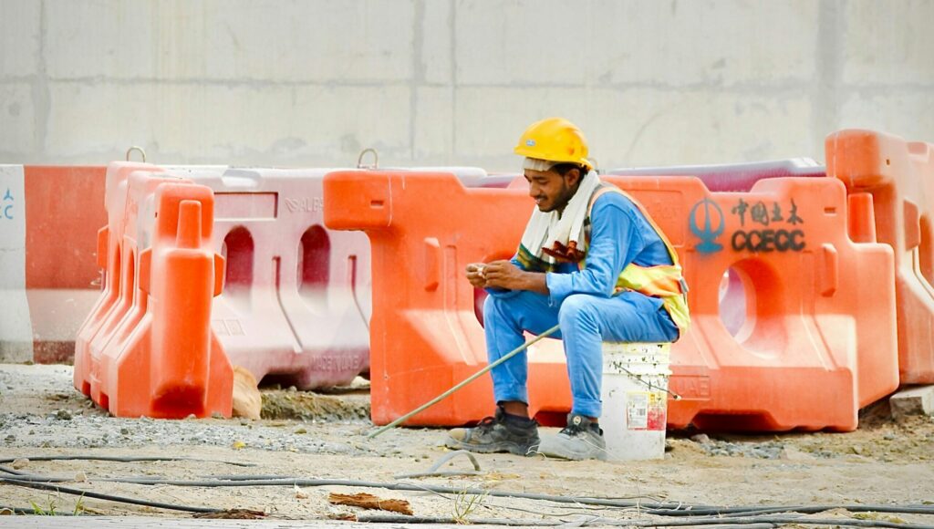 Construction worker looking at phone and browsing online | itvibes full service digital marketing agency in houston Construction Worker Looking at Phone and Browsing Online