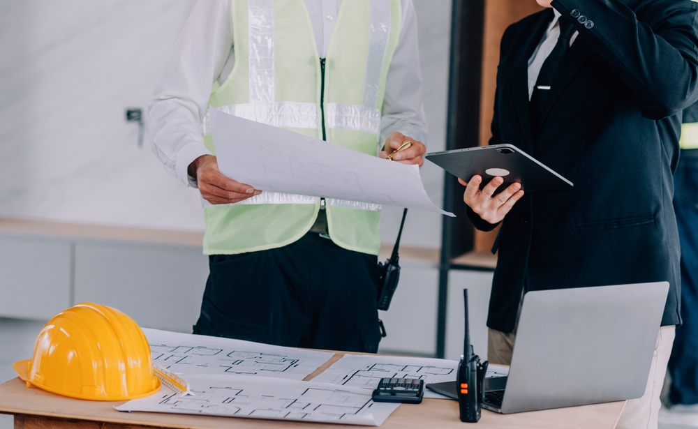 Diverse Team of Specialists Using Table for General Contractor Ads Diverse Team of Specialists Using Table for General Contractor Ads