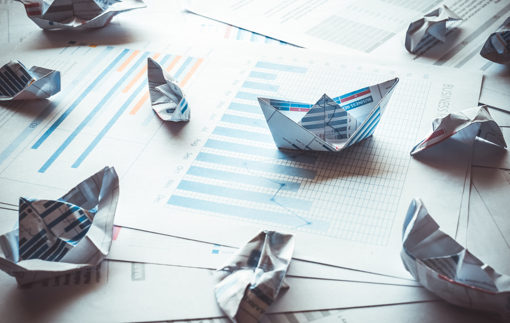 Group of boat made with paper graph in stormy of business.Only one boat can be success.