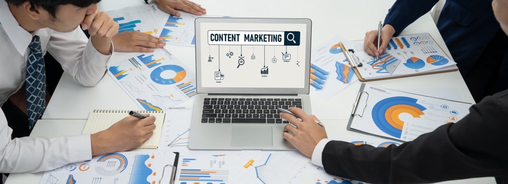 Business professional reviewing content marketing data and digital performance metrics on a laptop for online business growth.