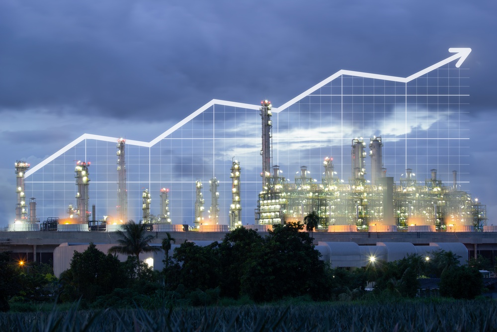 an Illuminated Industrial Complex Featuring Cooling Towers of a Power Plant and Towering Refinery Distillation Columns Glows Beneath a Dramatic Twilight Sky the Large scale Energy Infrastructure is Overlaid with a Prominent Upward trending Financial Graph Symbolizing Economic Growth Industrial Expansion and Rising Production Within the Manufacturing Sector Massive Pipelines Processing Facilities and Advanced Engineering Structures Highlight Modern Energy Technology Petrochemical Operations and Large scale Industrial Productivity the Futuristic Industrial Landscape Represents Increasing Market Demand Business Profitability and Infrastructure Investment Driven by Power Generation and Refinery Operations This Professional Business Concept is Ideal for Energy Industry Presentations Economic Development Visuals Growth Marketing and Commercial Projects Related to Manufacturing Fuel Production and Technological Advancement