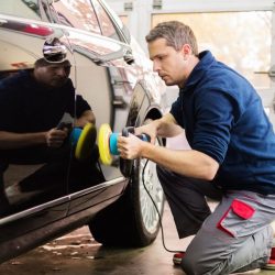 man buffing car in shop