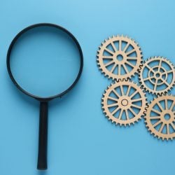 a Picture of Magnifying Glass with Arrange Gear on Blue Background Technical and Performance Analysis Concept